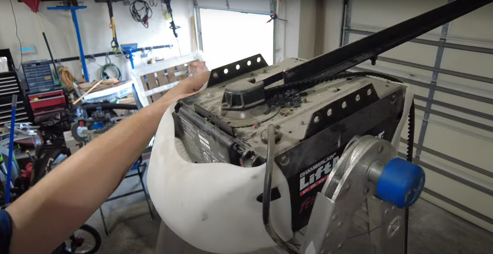 An experienced technician fixing a garage door opener mechanism to improve functionality and resolve common errors.