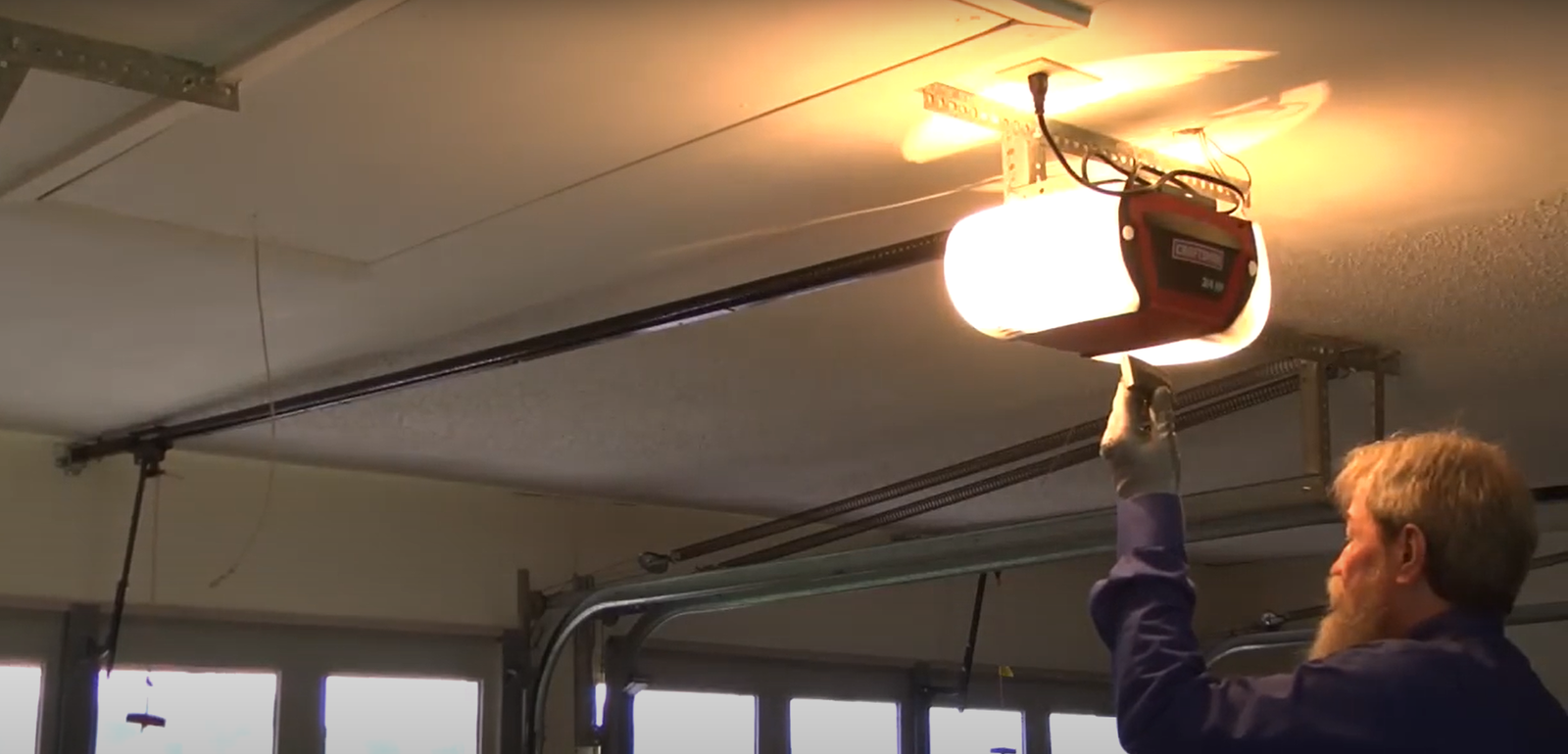 Expert performing professional garage door opener installation with precision