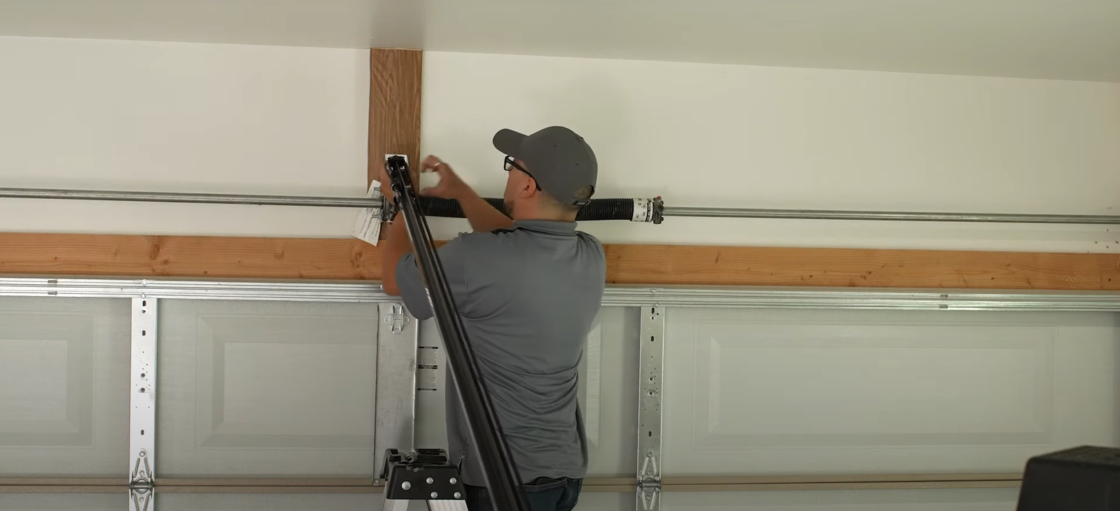 Technician from Garage Doors Repair Myakka City fixing garage door springs to enhance home security and functionality.
