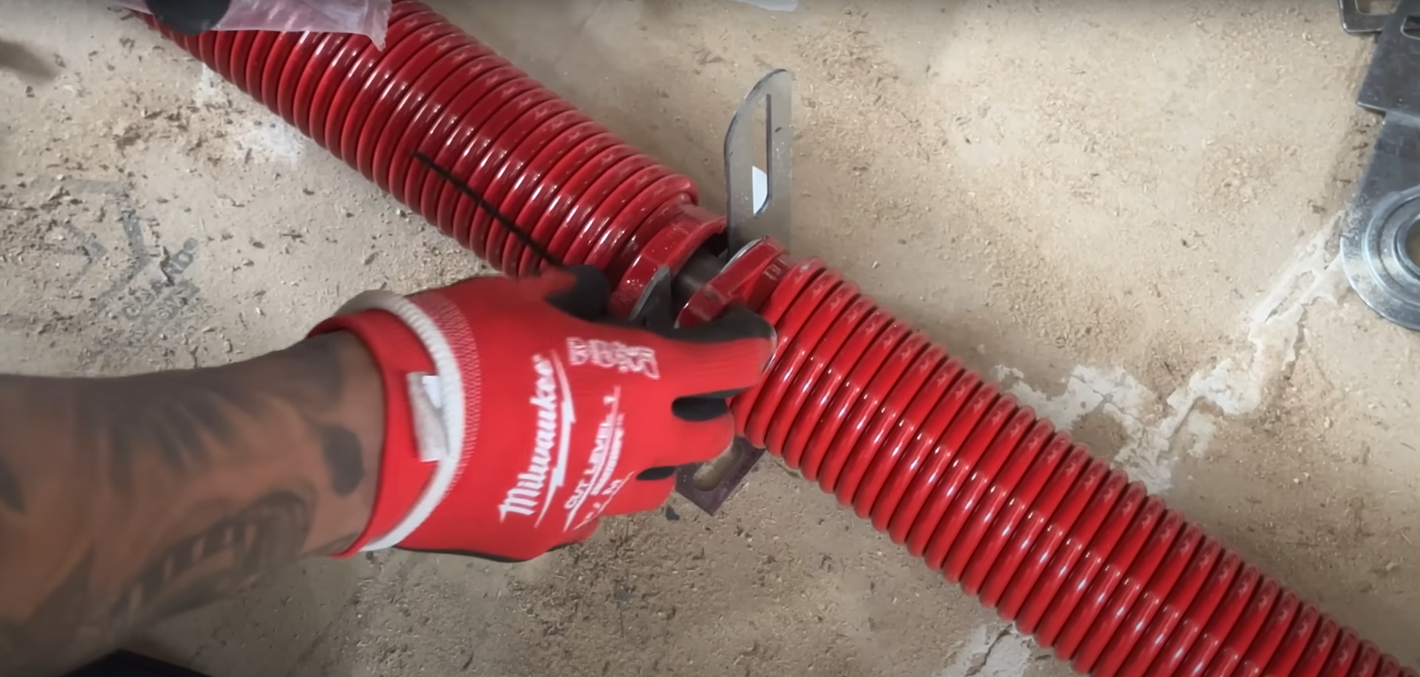 "Expert technician from Garage Doors Repair Myakka City installing a torsion spring on a residential garage door."